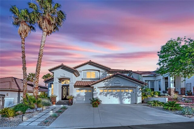 9705 Cameo Rose Ln, Las Vegas, NV 89134 - mediterranean / spanish house featuring a tile roof, driveway, stucco siding, and a garage