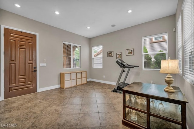 workout area with recessed lighting, baseboards, and tile patterned flooring