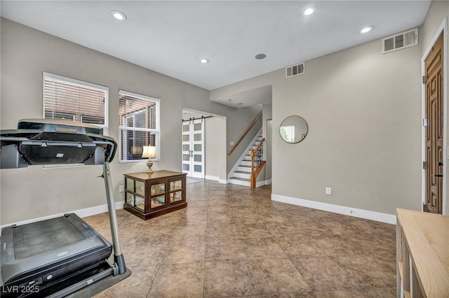 workout room featuring baseboards, recessed lighting, and a barn door