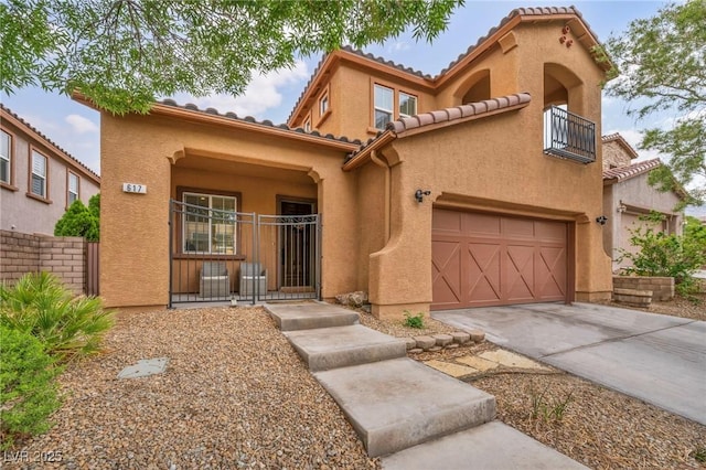 mediterranean / spanish-style home with concrete driveway, stucco siding, a tile roof, and a garage