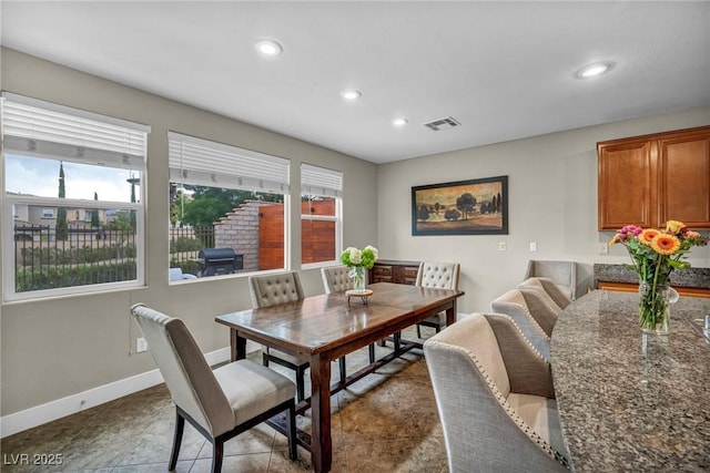 dining room with healthy amount of natural light, recessed lighting, and baseboards