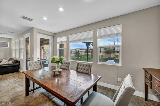 dining room with baseboards, plenty of natural light, and recessed lighting