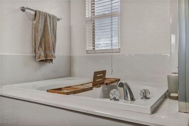 full bath featuring plenty of natural light and a garden tub