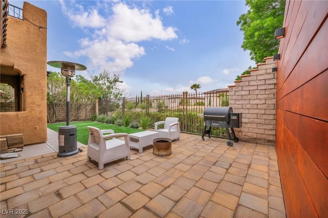 view of patio with fence and a grill