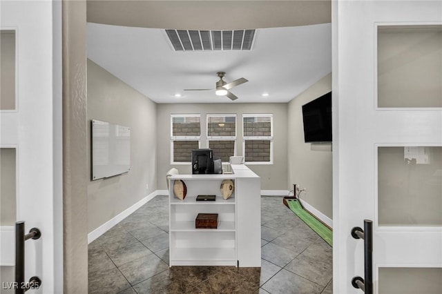 office area with ceiling fan, tile patterned flooring, and baseboards