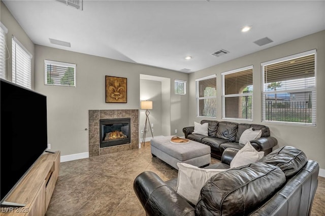 living area with baseboards, a fireplace, recessed lighting, and tile patterned flooring