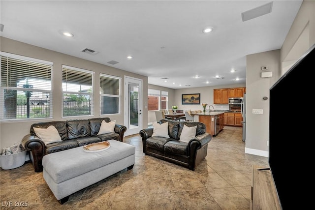 living area featuring recessed lighting, baseboards, and light tile patterned floors