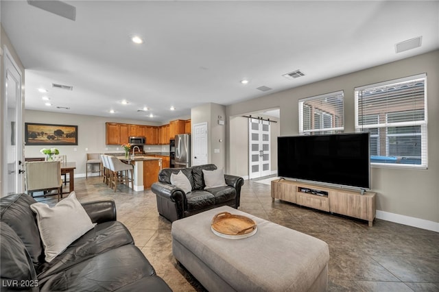 617 Apricot Rose Pl, Las Vegas, NV 89138 - living area with a barn door, recessed lighting, and light tile patterned floors