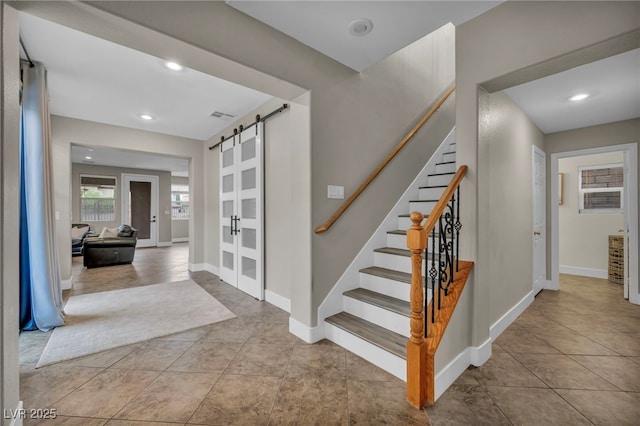 617 Apricot Rose Pl, Las Vegas, NV 89138 - staircase featuring a barn door, tile patterned flooring, and recessed lighting