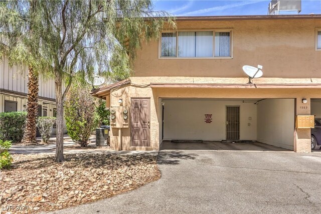 1553 Dorothy Ave Unit 4, Las Vegas, NV 89119 - townhome / multi-family property featuring stucco siding, driveway, and a garage