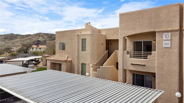 2232 Aspen Mirror Way Unit 202, Laughlin, NV 89029 - rear view of property featuring a balcony, a mountain view, and stucco siding
