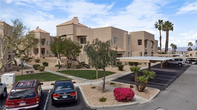 2232 Aspen Mirror Way Unit 202, Laughlin, NV 89029 - view of building exterior featuring covered and uncovered parking and a residential view