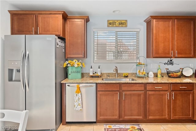 2213 Chandler Ranch Pl, Laughlin, NV 89029 - kitchen with appliances with stainless steel finishes, a sink, light stone counters, and light tile patterned floors