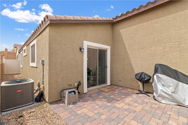2213 Chandler Ranch Pl, Laughlin, NV 89029 - rear view of property featuring central AC unit, stucco siding, a patio, and fence