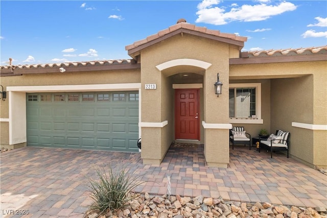 2213 Chandler Ranch Pl, Laughlin, NV 89029 - view of front of house featuring stucco siding, a garage, driveway, and a tile roof