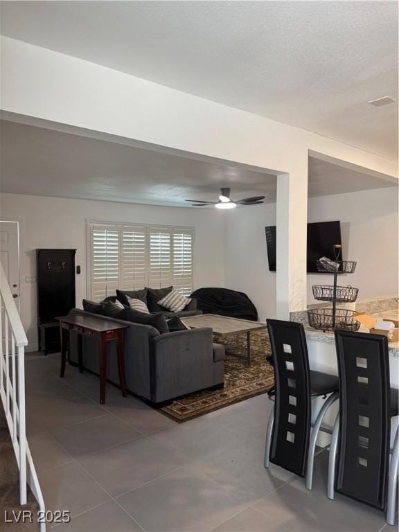 tiled living room featuring a ceiling fan