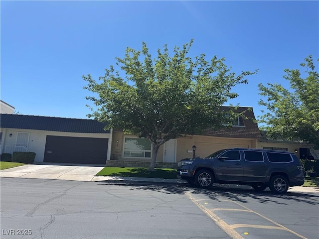 obstructed view of property with a garage and driveway