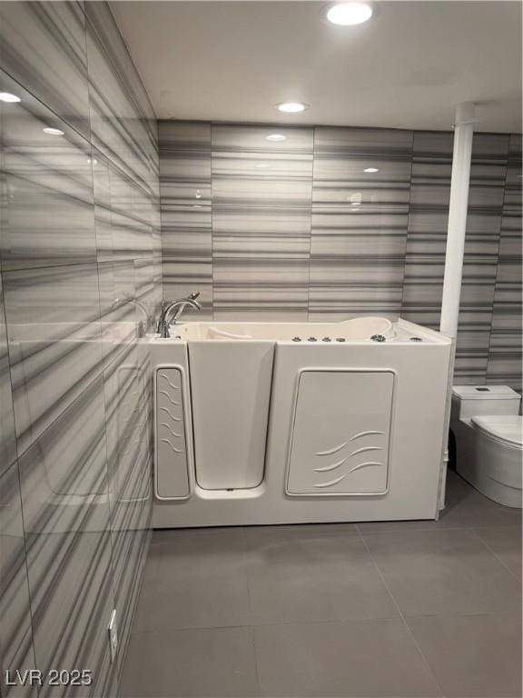 washroom with tile walls, tile patterned floors, and recessed lighting