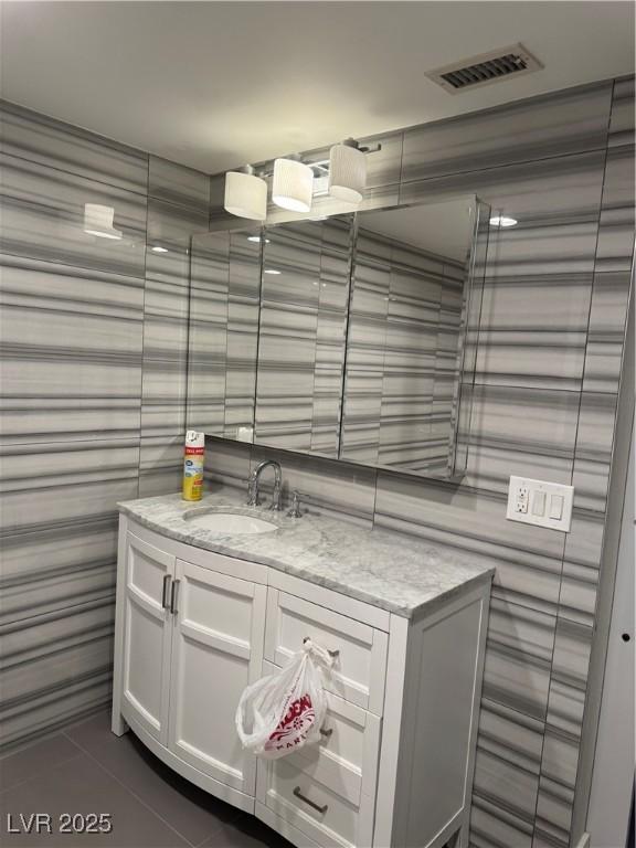 bathroom with tile patterned flooring and vanity