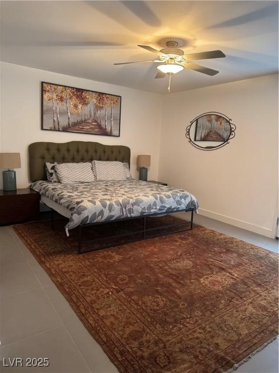 tiled bedroom with ceiling fan