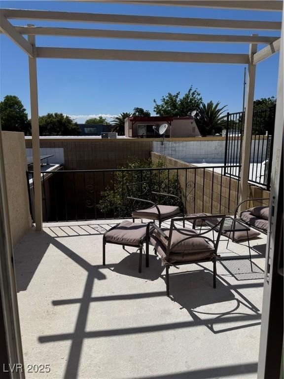 view of patio featuring a balcony