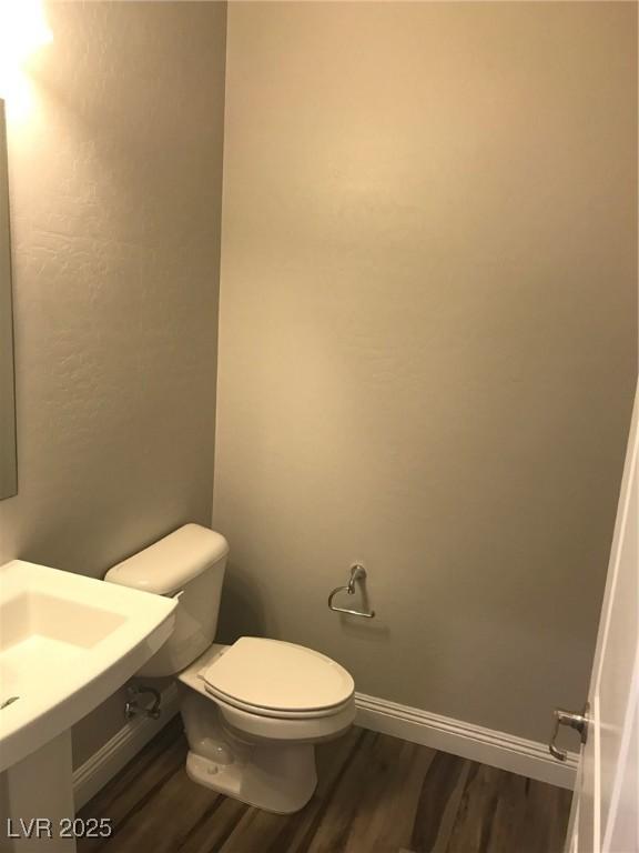 1027 Cambridge Park St, Las Vegas, NV 89148 - bathroom with wood finished floors, toilet, and baseboards