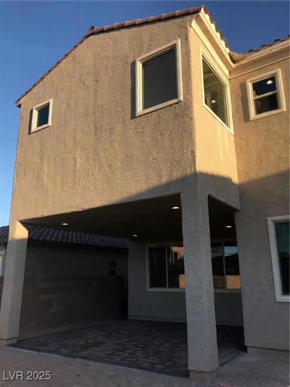 1027 Cambridge Park St, Las Vegas, NV 89148 - rear view of house with stucco siding, a tiled roof, and a patio
