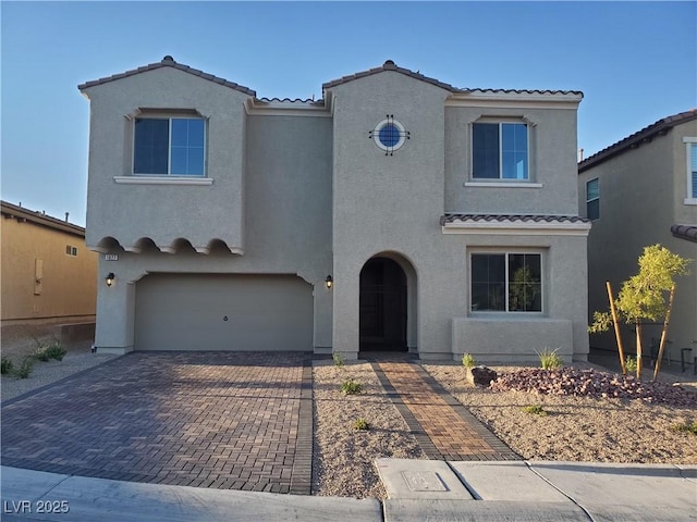 1027 Cambridge Park St, Las Vegas, NV 89148 - mediterranean / spanish house featuring a tiled roof, stucco siding, and an attached garage