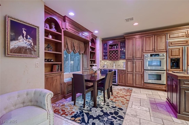 7501 Midnight Rambler St, Las Vegas, NV 89149 - dining space with wine cooler, recessed lighting, stone tile floors, and built in features