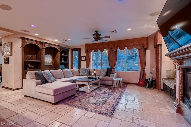 7501 Midnight Rambler St, Las Vegas, NV 89149 - living room with a glass covered fireplace, stone tile floors, recessed lighting, and ceiling fan