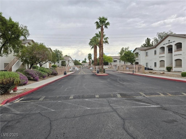 5655 E Sahara Ave Unit 2020, Las Vegas, NV 89142 - view of asphalt street with a gate, curbs, sidewalks, and a gated entry