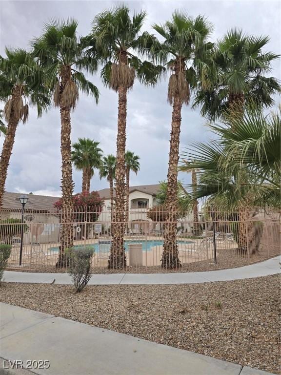 view of home's community featuring fence and a pool