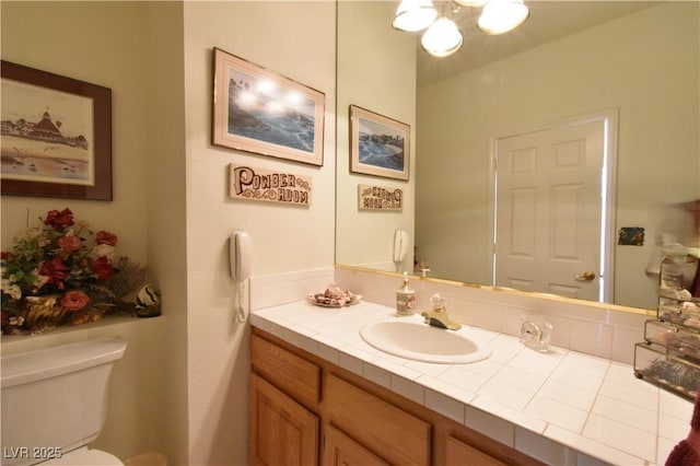half bath featuring toilet and vanity