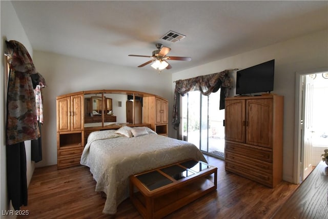 bedroom with access to outside, wood finished floors, and arched walkways