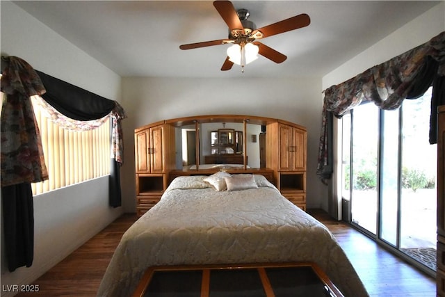 bedroom with access to exterior and dark wood-style floors