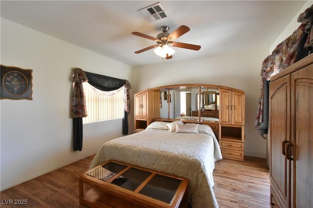 bedroom with light wood-style floors and a ceiling fan