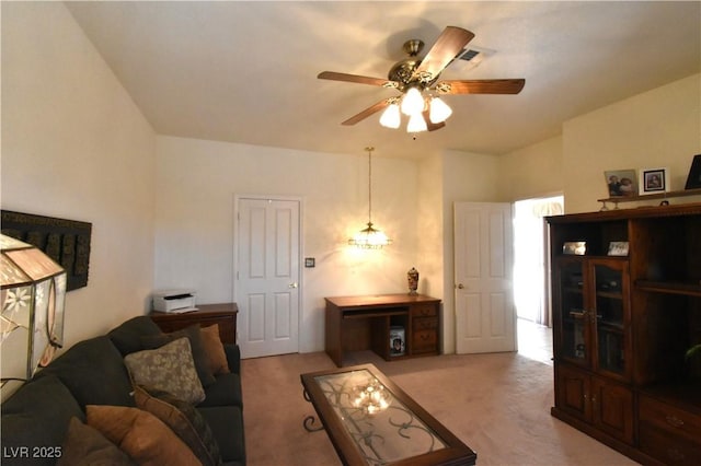 carpeted living area featuring ceiling fan