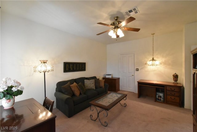 carpeted living area featuring a ceiling fan