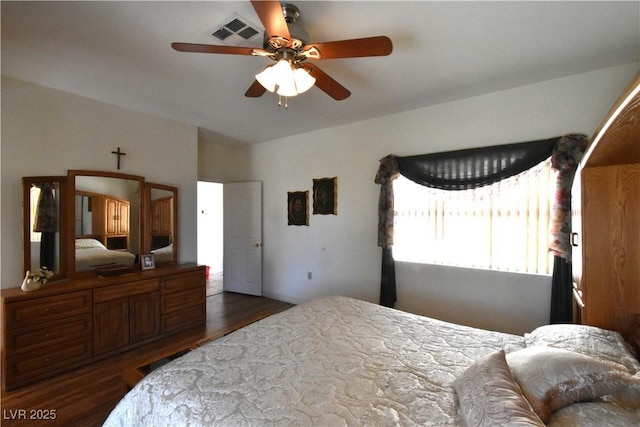 bedroom with dark wood-type flooring and ceiling fan