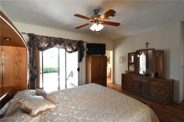 bedroom featuring wood finished floors, access to outside, and a ceiling fan