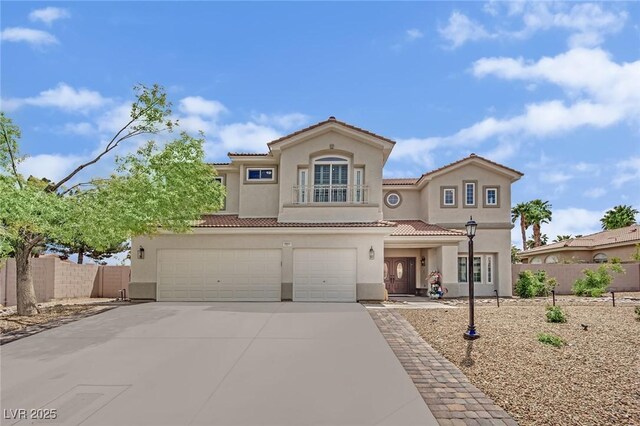 7211 Heggie Ave, Las Vegas, NV 89131 - mediterranean / spanish-style home with stucco siding, fence, concrete driveway, a tile roof, and an attached garage