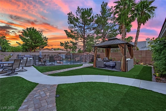 7211 Heggie Ave, Las Vegas, NV 89131 - yard at dusk featuring outdoor lounge area, a gazebo, and a patio area