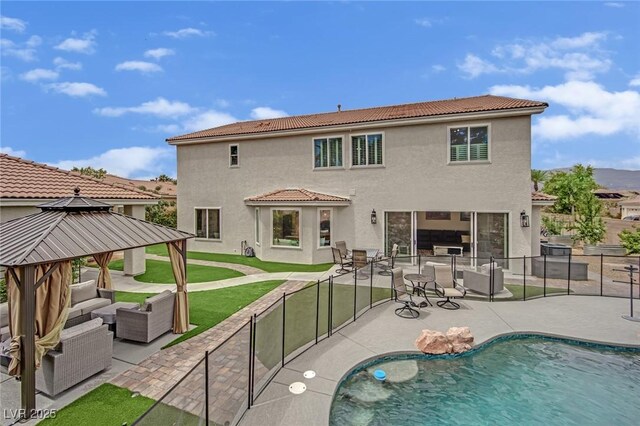 7211 Heggie Ave, Las Vegas, NV 89131 - rear view of house featuring an outdoor living space, a gazebo, a patio area, and stucco siding