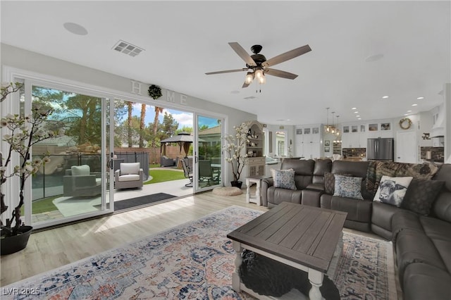 7211 Heggie Ave, Las Vegas, NV 89131 - living room featuring light wood-style flooring, a ceiling fan, plenty of natural light, and recessed lighting