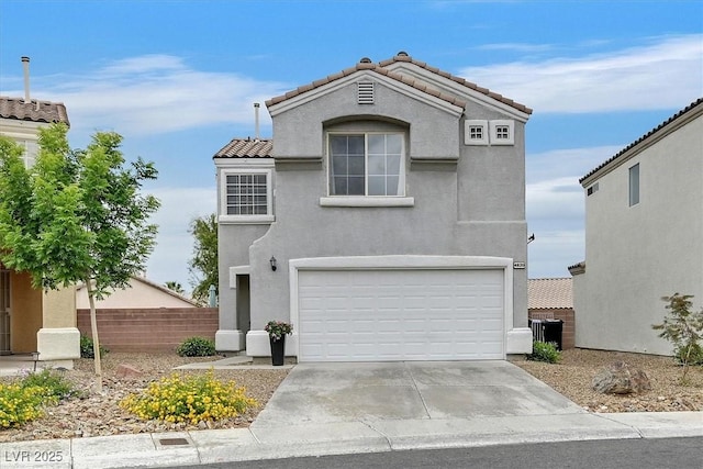 4820 Integrity St, North Las Vegas, NV 89031 - view of front of house featuring stucco siding, a tiled roof, a garage, and fence
