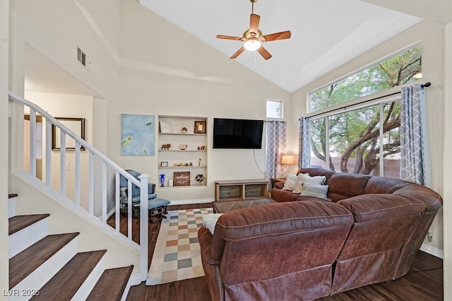 4820 Integrity St, North Las Vegas, NV 89031 - living room with wood finished floors, ceiling fan, stairs, high vaulted ceiling, and baseboards