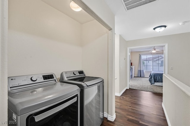4820 Integrity St, North Las Vegas, NV 89031 - washroom featuring washing machine and dryer, dark wood-style flooring, baseboards, and a ceiling fan