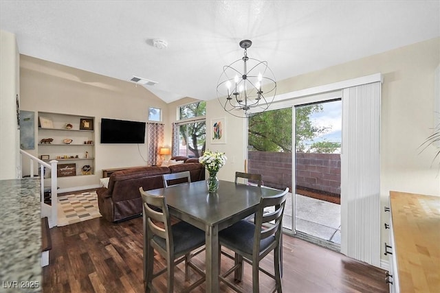 4820 Integrity St, North Las Vegas, NV 89031 - dining space featuring dark wood-style floors, lofted ceiling, a chandelier, and built in shelves