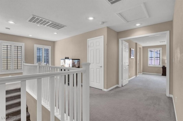 corridor with carpet floors, baseboards, and recessed lighting