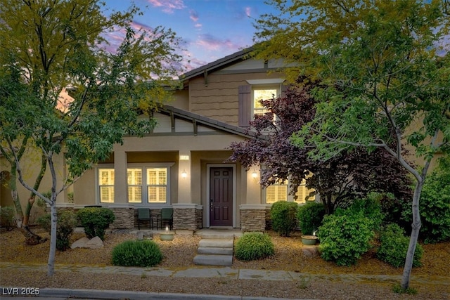 view of front facade with stone siding and stucco siding